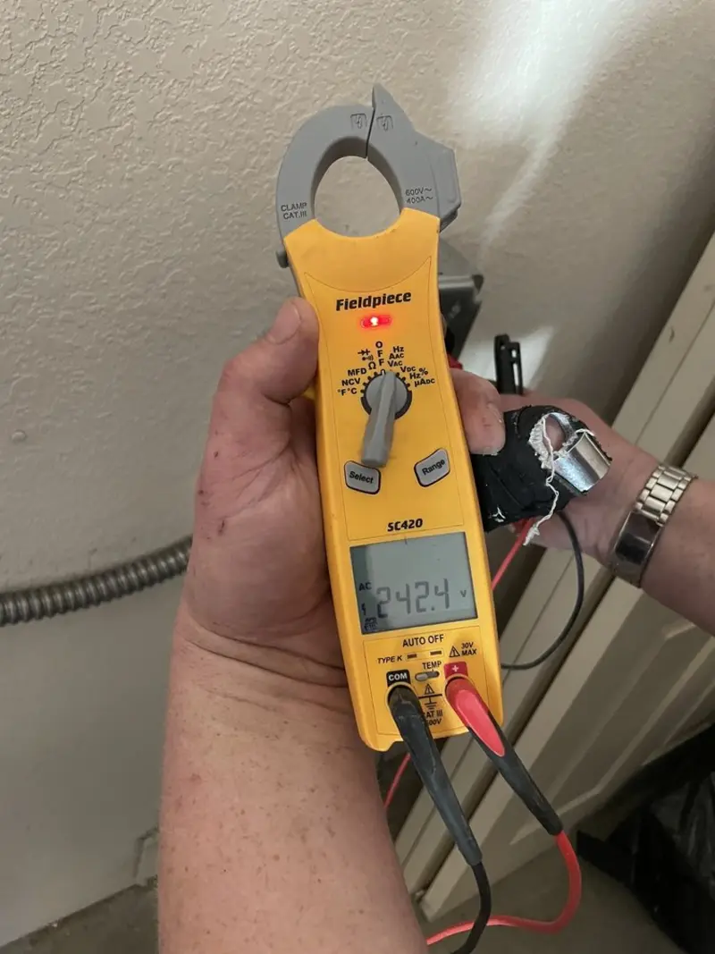 Voltage testing with clamp meter during Recessed Lighting Installation in Coppell
